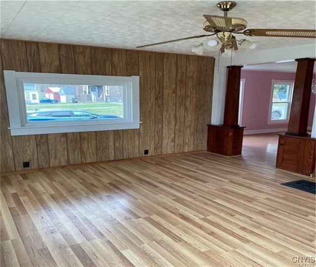 622 Fulton St, Wilna, NY 13619 - interior space featuring a ceiling fan, wooden walls, baseboards, and wood finished floors