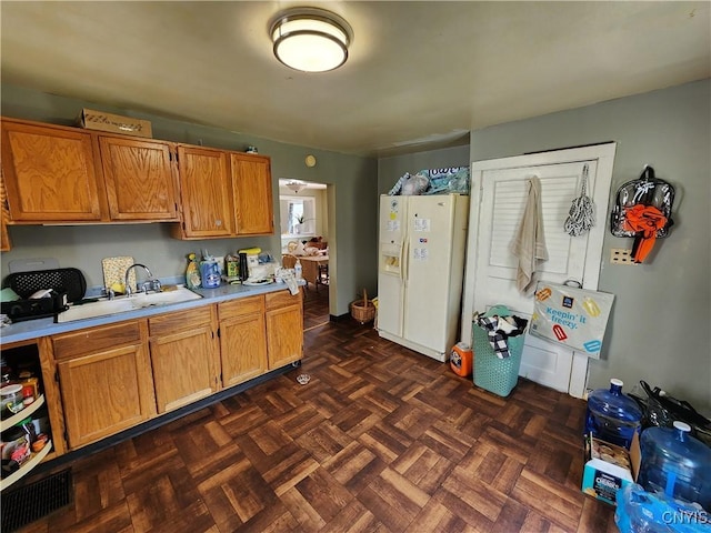903 Milton Ave, Syracuse, NY 13204 - kitchen featuring visible vents, a sink, light countertops, brown cabinets, and white refrigerator with ice dispenser