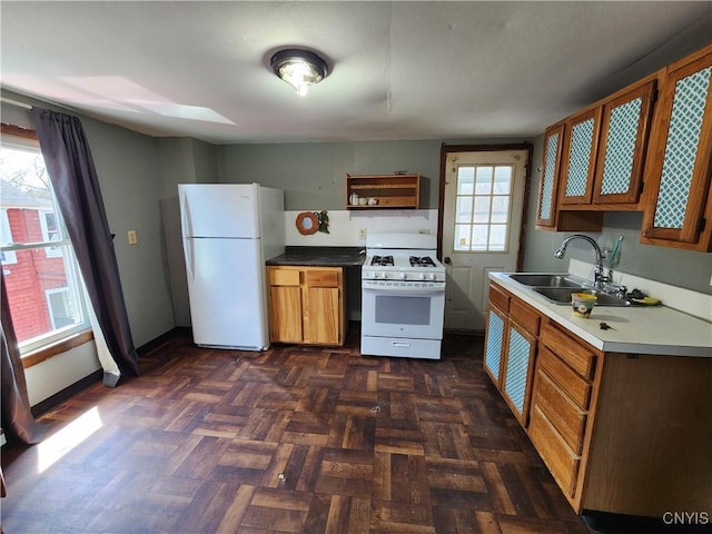 903 Milton Ave, Syracuse, NY 13204 - kitchen with open shelves, brown cabinets, a sink, and white appliances