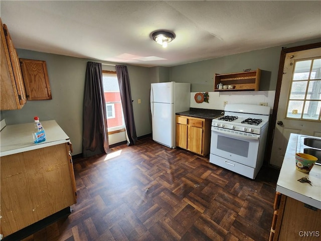 903 Milton Ave, Syracuse, NY 13204 - kitchen with white appliances, brown cabinetry, and a healthy amount of sunlight