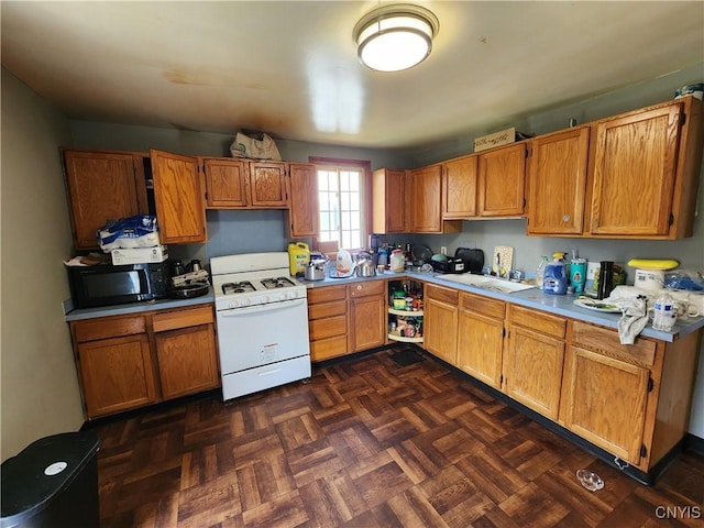 903 Milton Ave, Syracuse, NY 13204 - kitchen featuring light countertops, black microwave, gas range gas stove, and brown cabinetry