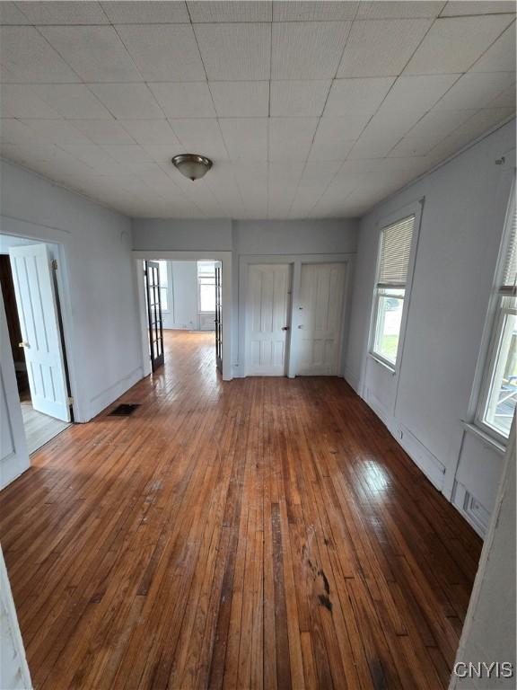 interior space featuring visible vents, hardwood / wood-style floors, and a healthy amount of sunlight