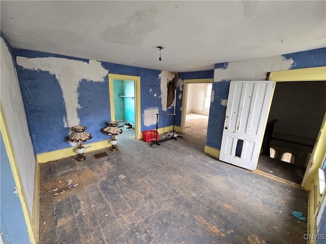 empty room featuring baseboards and hardwood / wood-style floors