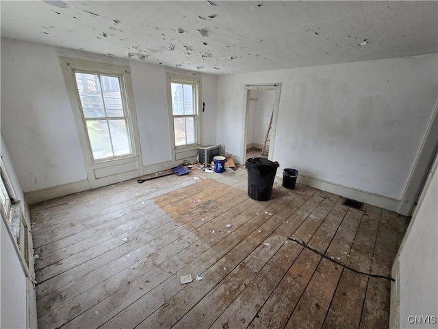 unfurnished room with hardwood / wood-style flooring
