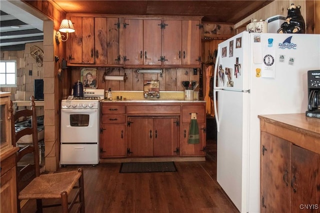 kitchen featuring brown cabinetry, white appliances, dark wood-style flooring, and light countertops