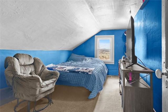 bedroom with carpet flooring and vaulted ceiling