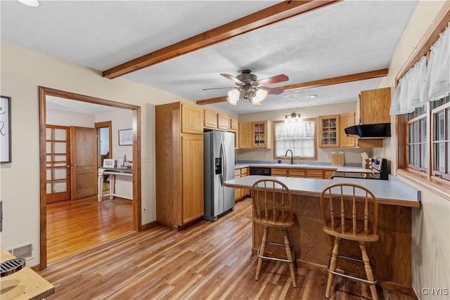 kitchen with stainless steel fridge with ice dispenser, electric range oven, beamed ceiling, light wood-style flooring, and a peninsula