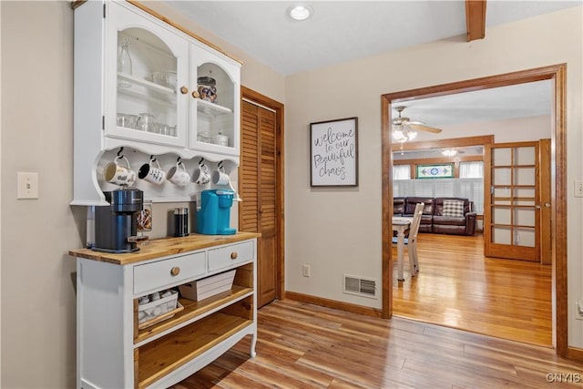 hallway with light wood-style flooring and baseboards