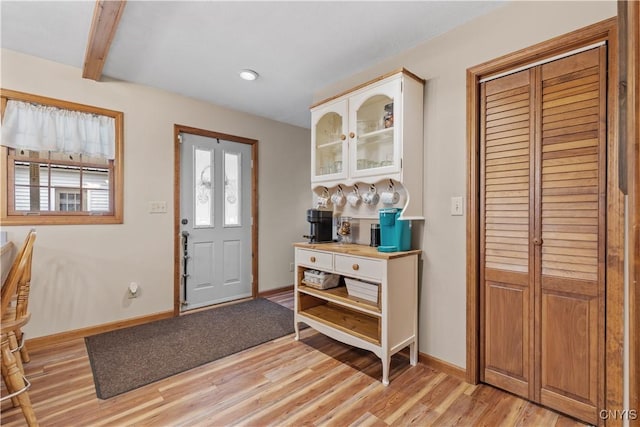 entrance foyer featuring light wood-type flooring, baseboards, recessed lighting, and beam ceiling