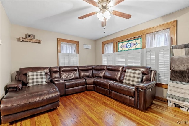 living area featuring light wood-type flooring and a ceiling fan