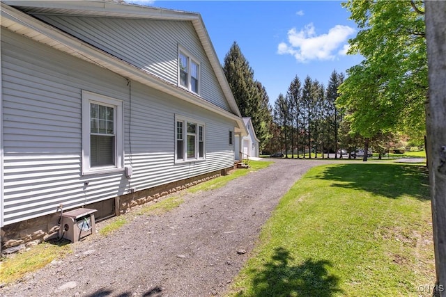 view of side of property with a lawn