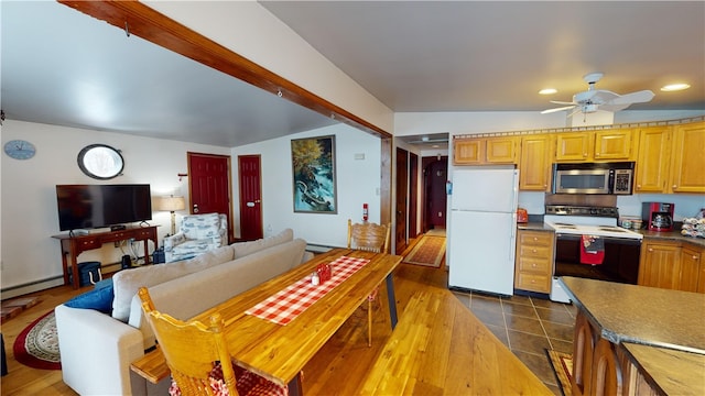 6761 State Highway 80, Otsego, NY 13326 - kitchen featuring range with electric stovetop, stainless steel microwave, freestanding refrigerator, a ceiling fan, and a baseboard radiator