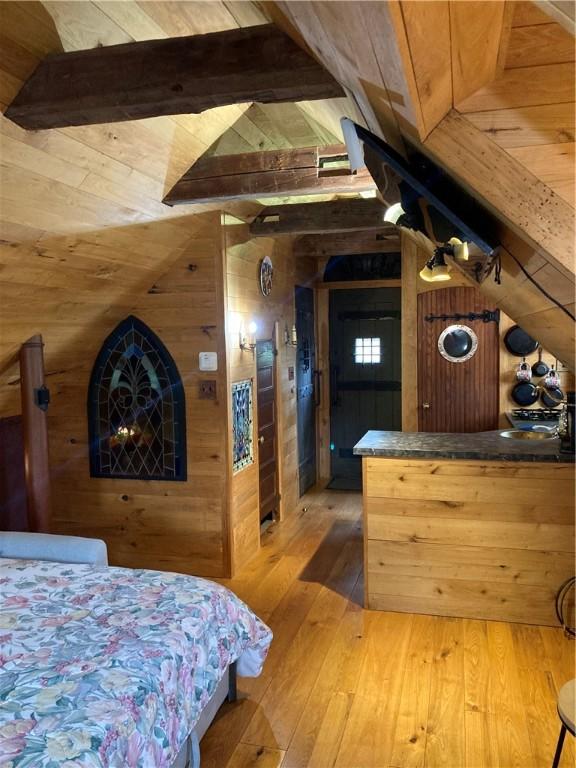 6761 State Highway 80, Otsego, NY 13326 - bedroom featuring wooden walls, hardwood / wood-style floors, and wooden ceiling