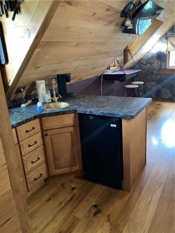6761 State Highway 80, Otsego, NY 13326 - bar area featuring light wood finished floors, lofted ceiling, dishwasher, and wooden walls