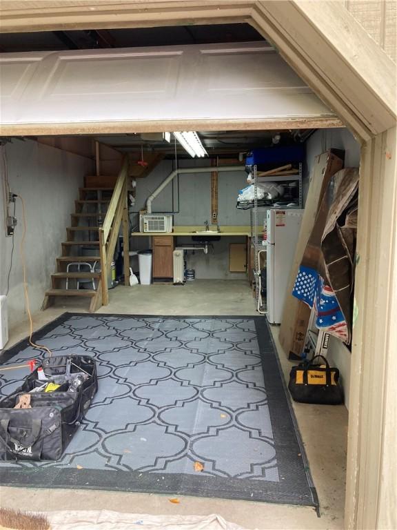 6761 State Highway 80, Otsego, NY 13326 - below grade area with freestanding refrigerator, a sink, and stairway