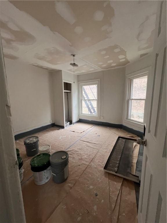 empty room featuring baseboards and a wealth of natural light