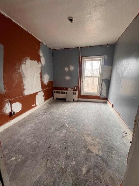 empty room featuring radiator heating unit