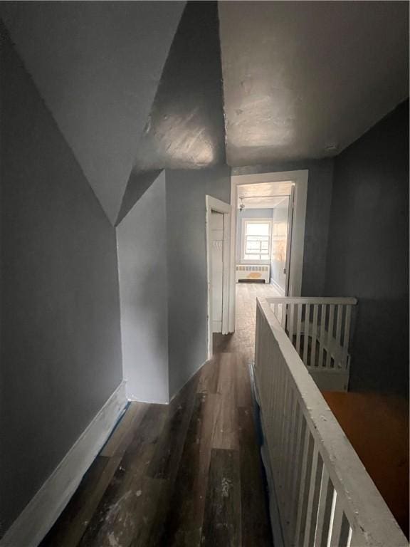 hallway featuring dark wood-type flooring and an upstairs landing