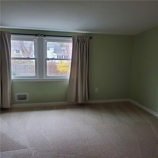 spare room with carpet floors and baseboards