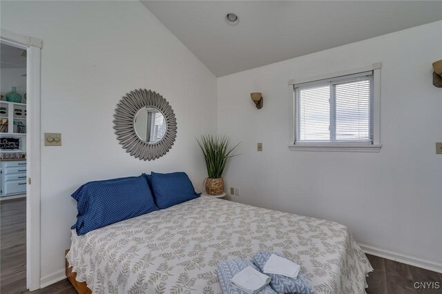 27180 Montonna Shores Rd N, Lyme, NY 13693 - bedroom featuring vaulted ceiling, dark wood-style floors, and baseboards