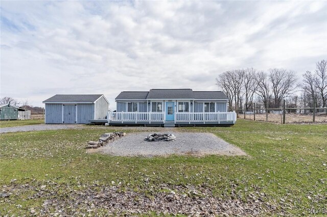 27180 Montonna Shores Rd N, Lyme, NY 13693 - back of property featuring fence, a yard, a shed, a wooden deck, and an outdoor structure