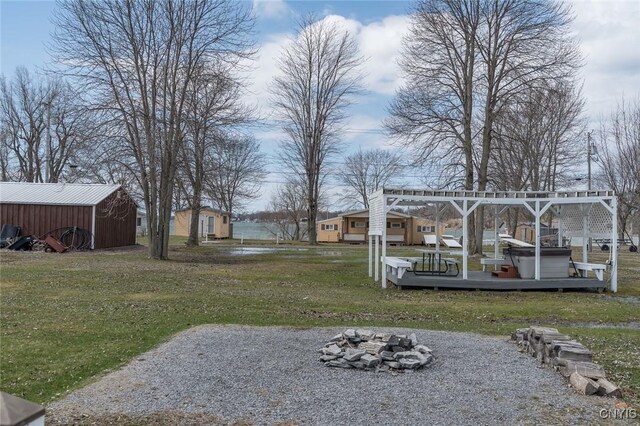 27180 Montonna Shores Rd N, Lyme, NY 13693 - view of yard with a fire pit and an outdoor structure