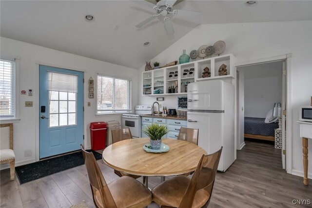 27180 Montonna Shores Rd N, Lyme, NY 13693 - interior space featuring lofted ceiling, a ceiling fan, white appliances, and light wood-type flooring