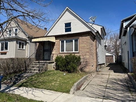 90 Alma Ave, Buffalo, NY 14215 - view of front of house with an outbuilding, a front yard, and a garage