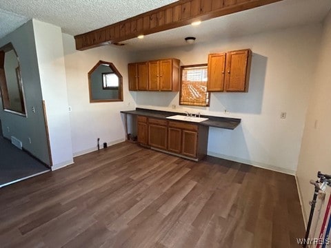90 Alma Ave, Buffalo, NY 14215 - kitchen featuring brown cabinets, baseboards, dark wood-style flooring, and a sink