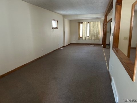 90 Alma Ave, Buffalo, NY 14215 - empty room with dark carpet, baseboards, and a textured ceiling