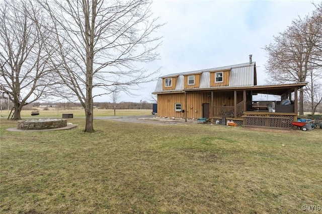 back of house with a porch and a yard