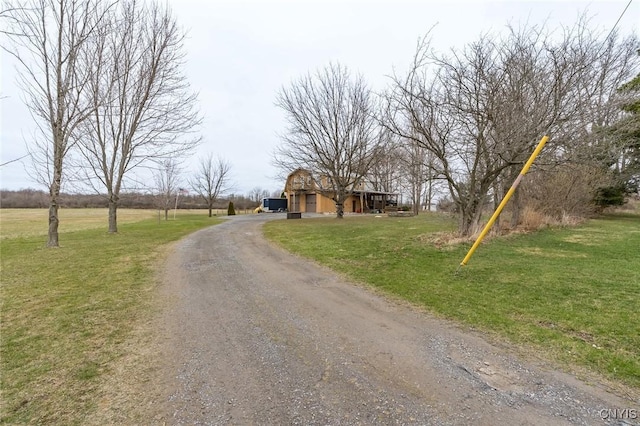view of road featuring dirt driveway