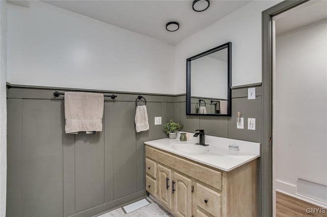 bathroom with wood finished floors and vanity