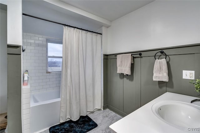 bathroom with shower / bath combo and a sink