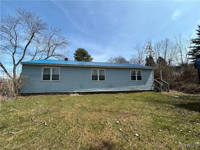 254-256 Bird Ave, Sidney, NY 13838 - back of property with a lawn and metal roof