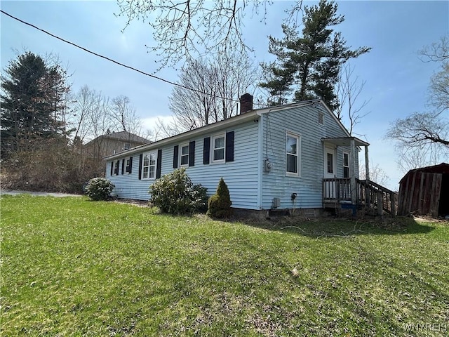view of property exterior with a yard and a chimney