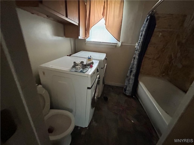 laundry room with washing machine and clothes dryer, baseboards, and laundry area