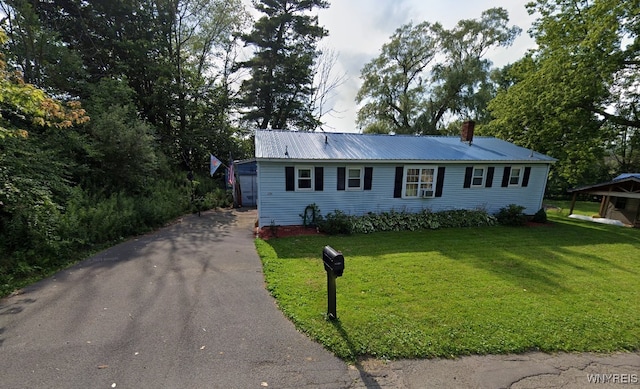 254-256 Bird Ave, Sidney, NY 13838 - view of front of home featuring a chimney, metal roof, a front lawn, and driveway