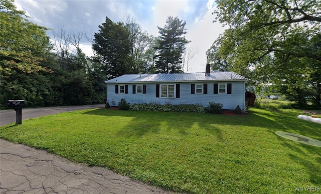 254-256 Bird Ave, Sidney, NY 13838 - view of front of house featuring a front lawn, a chimney, and metal roof