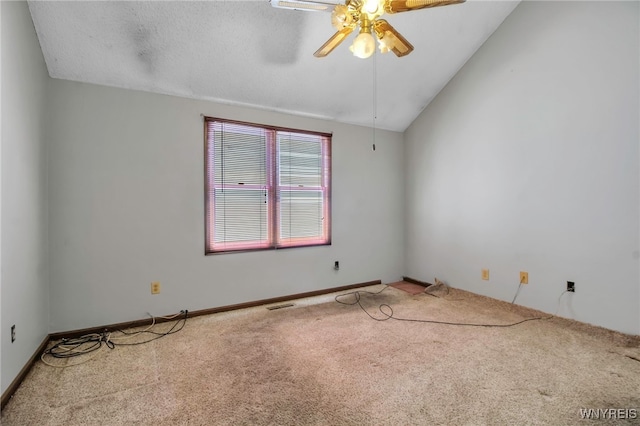 carpeted spare room with ceiling fan, lofted ceiling, visible vents, and baseboards