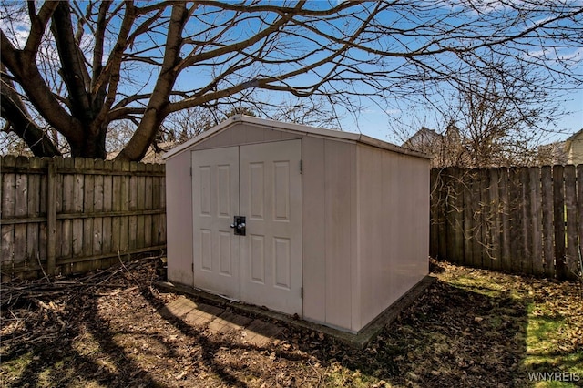 view of shed with a fenced backyard