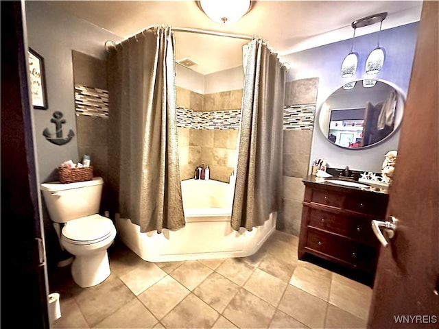 bathroom with tile patterned floors, vanity, toilet, and shower / bath combination with curtain