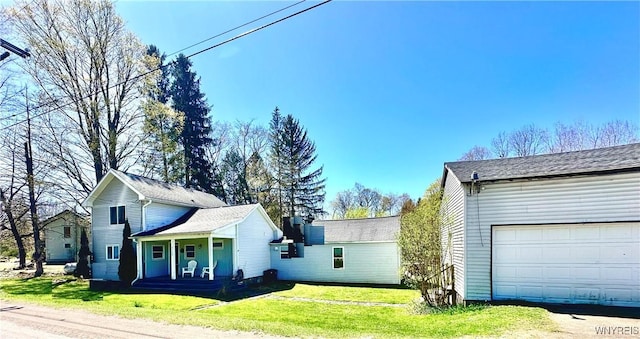 view of property exterior featuring covered porch, a garage, and a yard