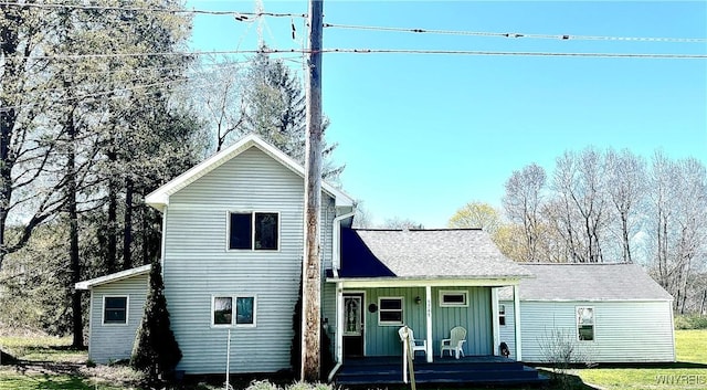 view of front of house with board and batten siding, a porch, and a front lawn