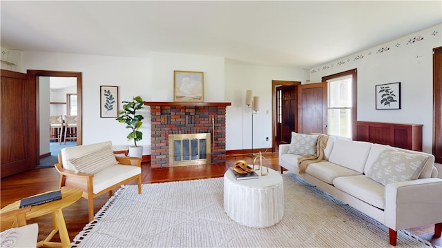 4501 State Route 414, Hector, NY 14818 - living room with a brick fireplace, a wealth of natural light, wood finished floors, and baseboards