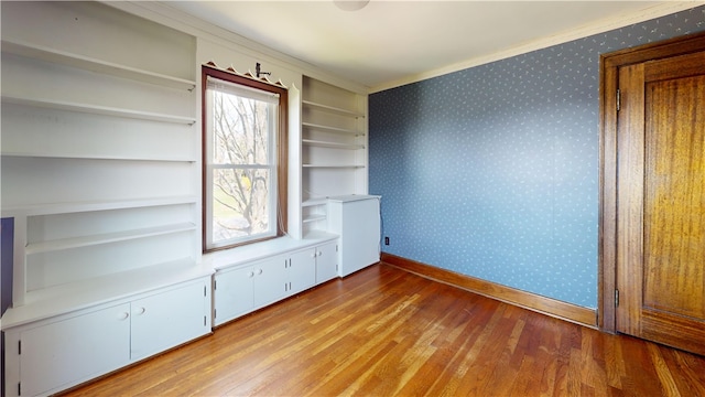 4501 State Route 414, Hector, NY 14818 - empty room featuring baseboards, ornamental molding, wood finished floors, and wallpapered walls