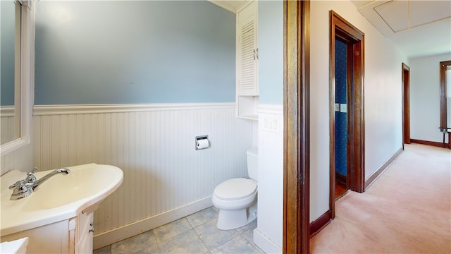 4501 State Route 414, Hector, NY 14818 - half bathroom with a wainscoted wall, baseboards, a sink, and toilet