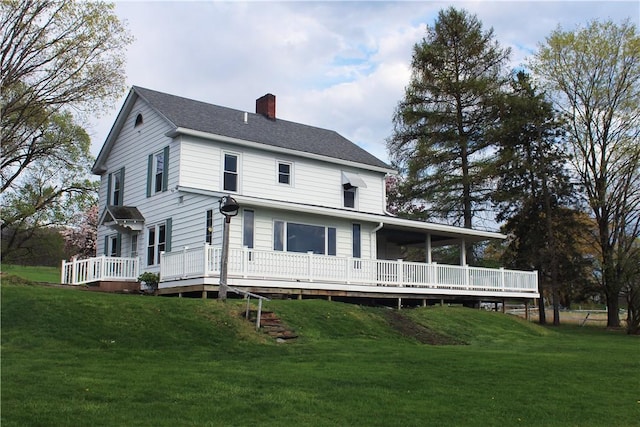 4501 State Route 414, Hector, NY 14818 - view of front of home featuring a chimney, a front yard, and a deck