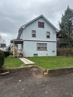 rear view of house with a lawn