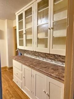 bar featuring baseboards and wood finished floors